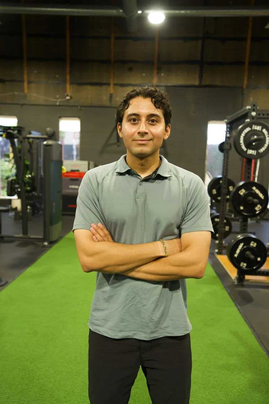 Sharan Gautam, the Continuum physiotherapist, standing in a rehabilitation and training space