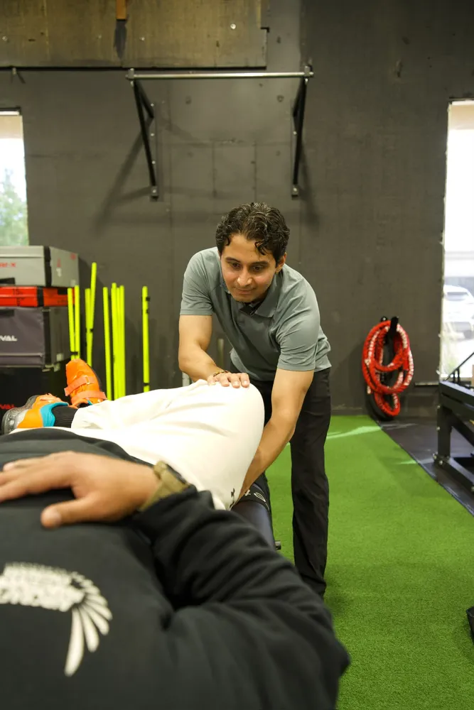 Close-up of hands-on physiotherapy treatment on a patient's hip