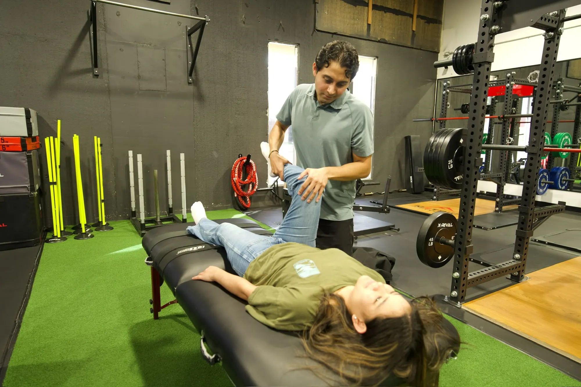 Physiotherapist gently stretching a patient's leg during a treatment session